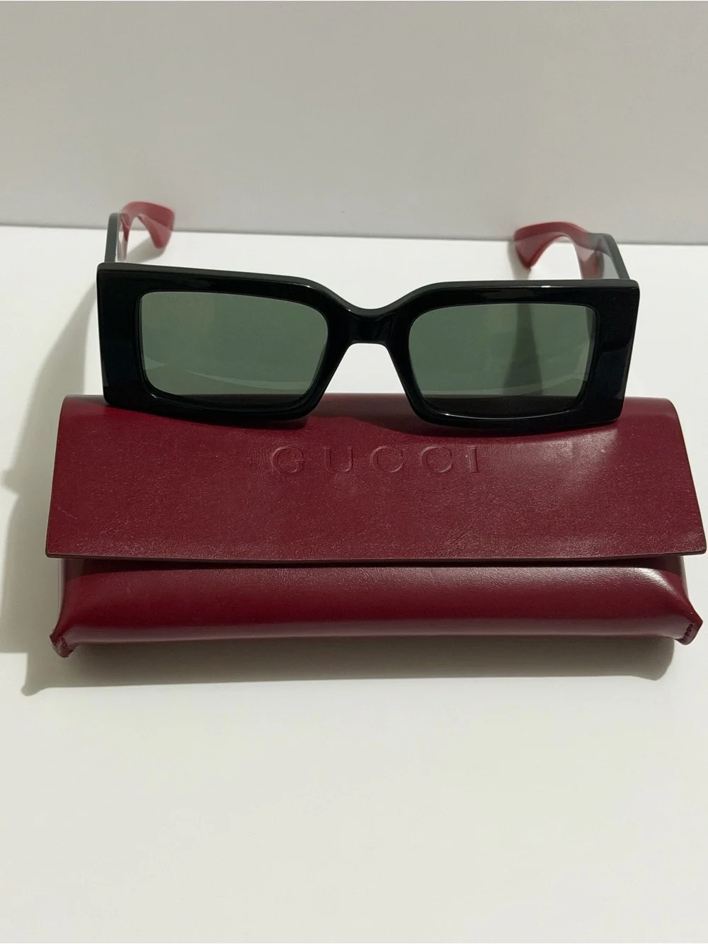 Gucci Black Frame Sunglasses with Red Temples and Gold Logo